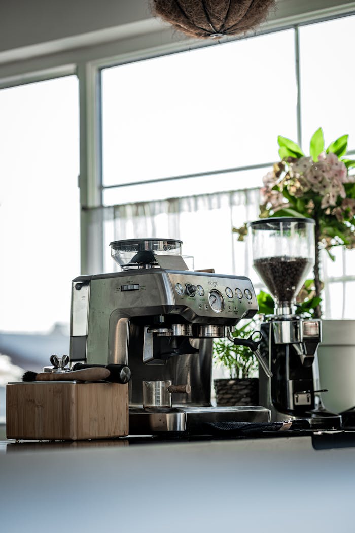 Stainless steel espresso machine in a bright, sunlit kitchen setting, perfect for coffee lovers.